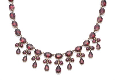 Lot 243 - A Garnet Fringe Necklace, circa 1850, the oval and pear cut garnets in foil backed settings, length