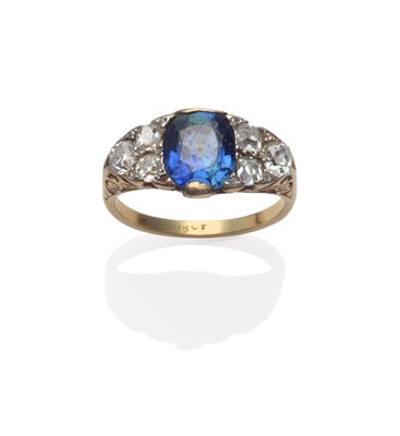 Lot 249 - A Sapphire and Diamond Ring, an oval mixed cut sapphire with a trio of old mine cut diamonds on...