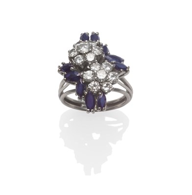 Lot 275 - A Sapphire and Diamond Cluster Ring, two floral clusters of round brilliant cut diamonds with...