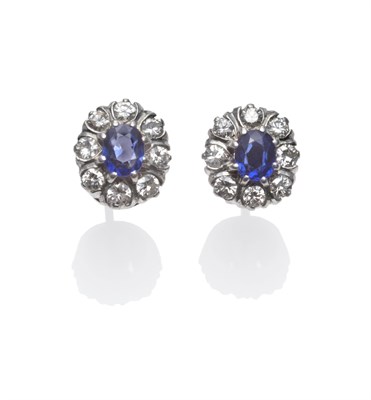 Lot 283 - A Pair of Sapphire and Diamond Cluster Earrings, an oval cut sapphire within a border of round...