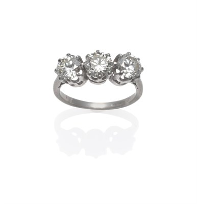 Lot 285 - A Diamond Three Stone Ring, the round brilliant cut diamonds in white claw settings, on a...