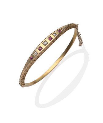 Lot 307 - A Ruby and Diamond Bangle, graduated old cut diamonds and rubies alternate within a panel, with...