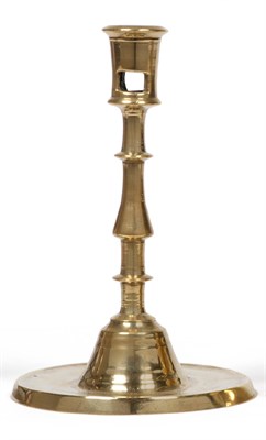 Lot 369 - A 16th Century Dutch Brass Candlestick, the shallow circular base with a depressed drip tray rising