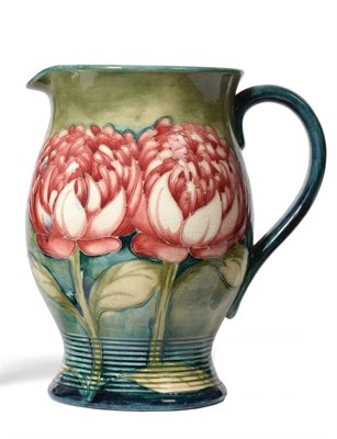 Lot 386 - A William Moorcroft Waratah Pattern Jug, of baluster form with ringed and waisted foot, on a...