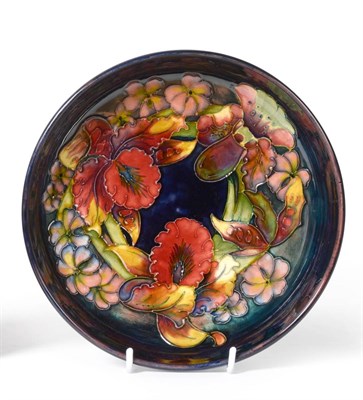 Lot 390 - A Walter Moorcroft Flambé Orchid and Spring Flowers Pattern Footed Bowl, impressed factory...