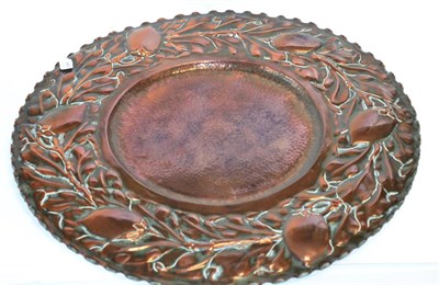 Lot 449 - An Arts & Crafts Copper Charger, embossed with strawberry plants border, fluted rim, painted...