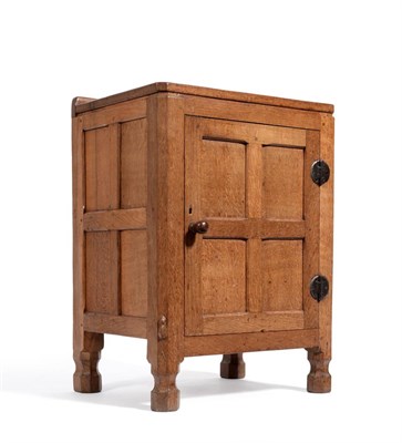 Lot 465 - A Robert  "Mouseman " Thompson Oak Bedside Cupboard, the raised up stand above a single...