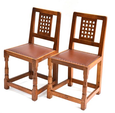 Lot 476 - A Pair of Robert  "Mouseman " Thompson Oak Lattice Back Chairs, on two octagonal front legs...