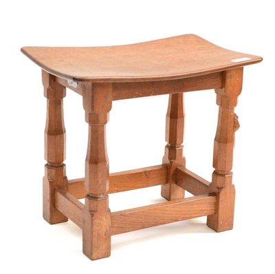 Lot 479 - A Robert  "Mouseman " Thompson Oak Dish Top Stool, the adzed top on four octagonal legs joined...