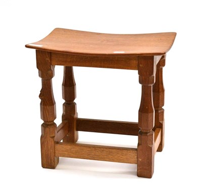 Lot 499 - A Robert  "Mouseman " Thompson Oak Dish Top Stool, on four octagonal legs joined by stretchers,...