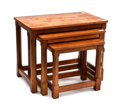 Lot 513 - A Robert  "Mouseman " Thompson Oak Nest-of-Tables, on four octagonal legs, each with carved...