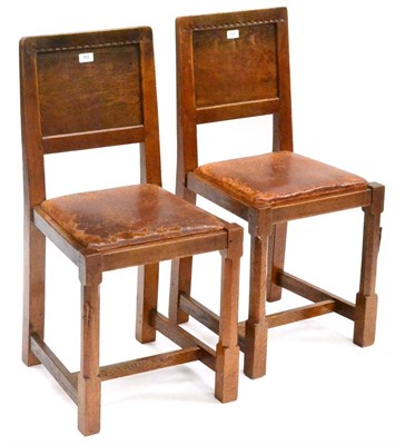 Lot 552 - A Pair of Derek  "Lizardman " Slater Oak Panel Back Dining Chairs, with carved triangular top rail