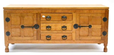 Lot 557 - A Sid Pollard of Thirsk Low Oak Sideboard, with two cupboard doors enclosing three drawers, on four