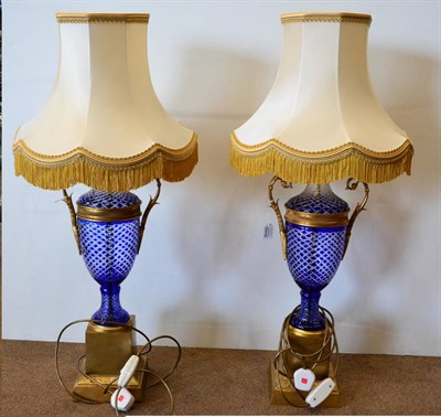 Lot 799 - A Pair of Gilt Metal Mounted Blue Overlay Glass Lamps, modern, of two-handled pedestal baluster...