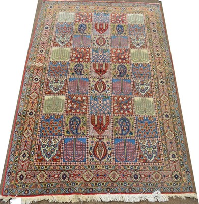 Lot 835 - Ghom Carpet Central Persia The compartmentalised field of polychrome Mihrabs and stylised...