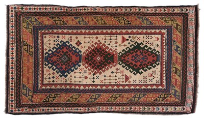 Lot 842 - Unusal Kazak Rug Central Caucasus The ivory field with three latchhook medallions surrounded by...