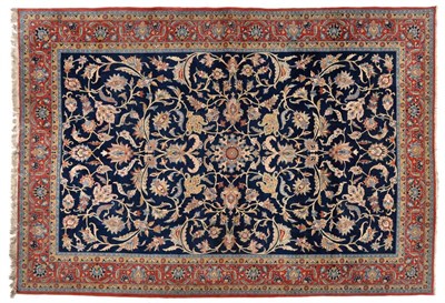 Lot 846 - Ghom Carpet Central Persia The deep indigo field of large palmettes and scrolling vines enclosed by