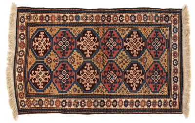 Lot 847 - Kazak Rug Central Caucausus The field with two columns of polychrome octagons containing hooked...