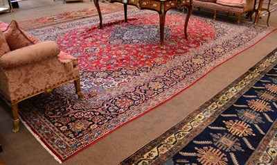 Lot 860 - Kashan Carpet  Central Persia The blood red field of scrolling vines around an indigo pole...