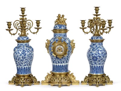 Lot 896 - A Blue and White Porcelain and Gilt Metal Mounted Striking Mantel Clock with Garniture, circa 1880