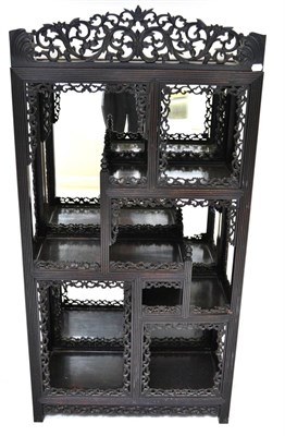 Lot 952 - A Chinese Hardwood Foliate Carved Display Cabinet, late 19th century, the three-quarter carved...