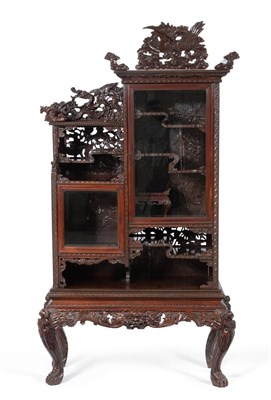 Lot 955 - An Early 20th Century Japanese Softwood Display Cabinet, richly carved all over with Chinese...