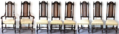 Lot 962 - A Set of Eight Beech and Cane Dining Chairs, the arched top rails above spindle turned supports and