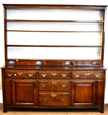 Lot 964 - A George III Oak Enclosed Dresser, late 18th century, the boarded top above five drawers flanked by