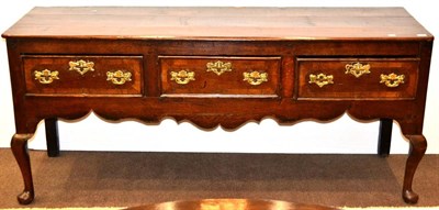 Lot 965 - A George III Oak Low Dresser, the three plank top above three frieze drawers, wavy shaped...