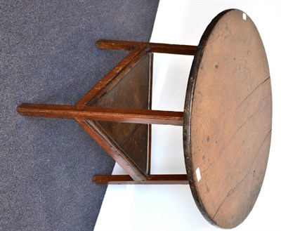 Lot 971 - An English Joined Oak Cricket Table, early 19th century, the one piece top of circular form, raised