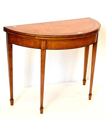 Lot 985 - A George III Satinwood, Tulipwood and Ebony Strung Foldover Card Table, circa 1800, with baize...