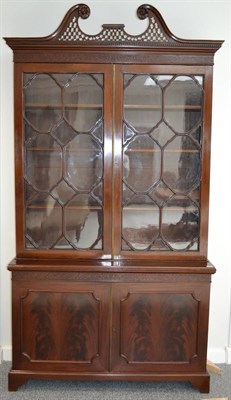 Lot 1000 - A Victorian Chippendale Revival Mahogany Bookcase, late 19th century, with pierced swan neck...