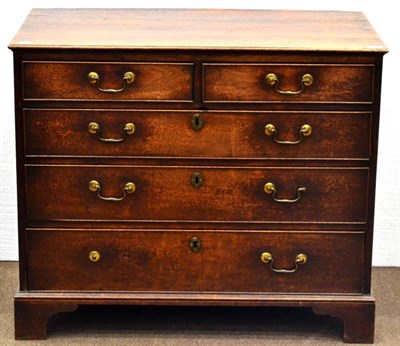 Lot 1005 - A George III Mahogany Breakfront Chest, late 18th century, the moulded top above two short and...