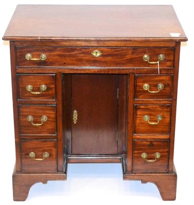 Lot 1006 - A Mahogany Kneehole Desk, in George III style, the moulded top above a long frieze drawer with...