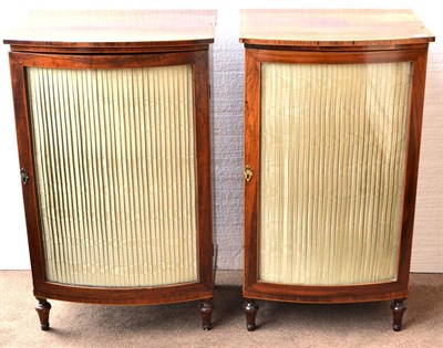 Lot 1016 - A Matched Pair of 19th Century Rosewood Bowfront Cabinets, with modern silk gathered glazed...