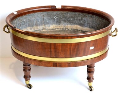 Lot 1023 - A Late George III Mahogany and Brass Bound Oval Wine Cooler, early 19th century, with lead...