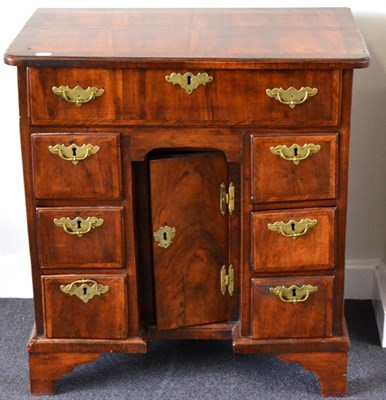 Lot 1038 - A George I Walnut and Feather Banded Kneehole Desk, early 18th century, the quarter-veneered...