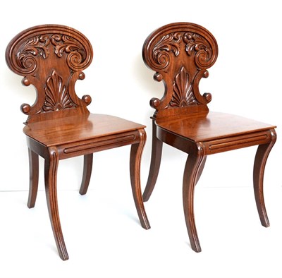 Lot 1056 - A Pair of Regency Carved Mahogany Hall Chairs, circa 1820, stamped Gillows, Lancaster, the acanthus