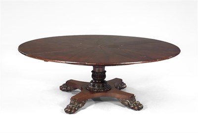 Lot 1063 - A Mahogany Jupe Style Table, the circular top opening to enclose eight triangular extending leaves