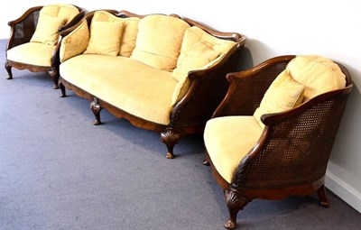 Lot 1095 - A 1920s Walnut Framed Double Cane Three Piece Bergère Suite, recovered in yellow and gold...