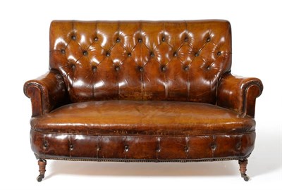 Lot 1100 - A Victorian Two-Seater Sofa, late 19th century, covered in vintage brown button leather, with...