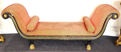 Lot 1101 - A Victorian Ebonised and Parcel Gilt Scroll End Sofa, late 19th century, in Regency style,...