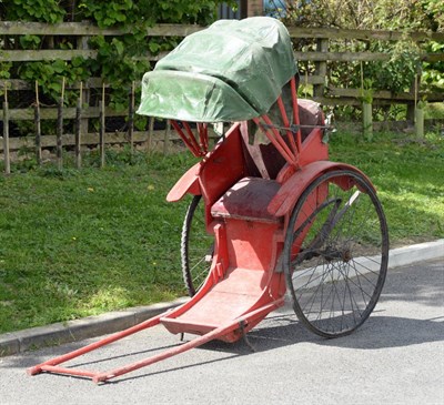 Lot 2001 - A Red Painted Rickshaw, late 19th/early 20th century  Green canvas folding hood above a padded seat