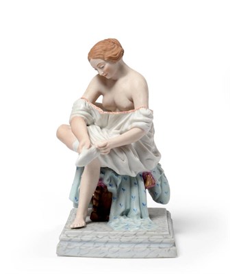 Lot 16 - A Russian Gardner Factory Bisque Porcelain Figure, circa 1890, depicting a seated scantily clad...