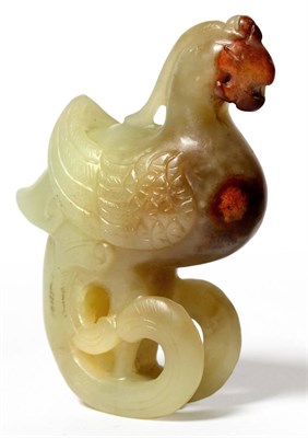 Lot 58 - A Chinese Jade Carving of a Phoenix, Qing Dynasty, the bird stylistically carved, pale green yellow