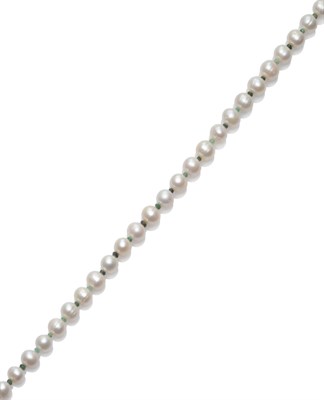 Lot 141 - A Cultured Pearl and Emerald Necklace, the oval cultured pearls alternate with faceted...