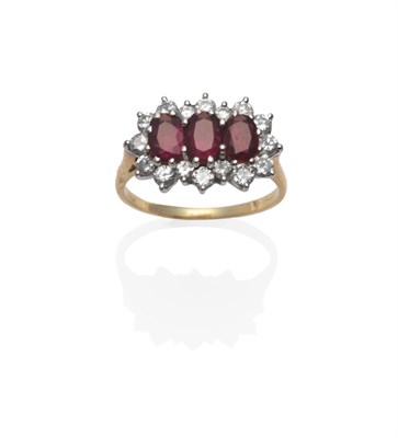 Lot 151 - An 18 Carat Gold Ruby and Diamond Triple Cluster Ring, the oval mixed cut rubies within a border of