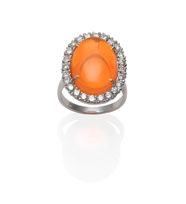 Lot 152 - An 18 Carat White Gold Fire Opal and Diamond Cluster Ring, an oval cabochon fire opal within a...