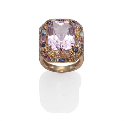 Lot 183 - A Contemporary Kunzite and Sapphire Ring, the scissor cut kunzite in a yellow claw setting within a