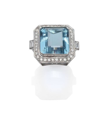 Lot 192 - An Aquamarine and Diamond Cluster Ring, a large step cut aquamarine within a border of round...